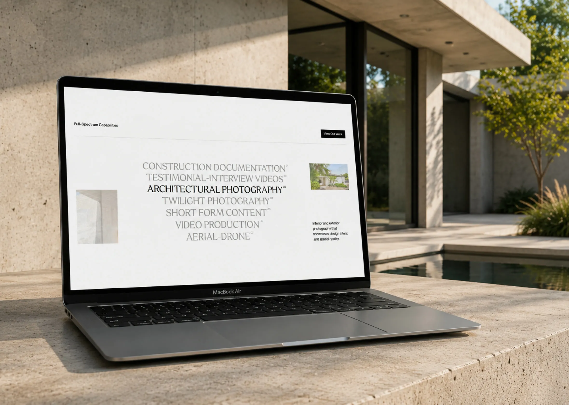 The Fabit services page on a laptop beside a concrete house: architectural photography and video.