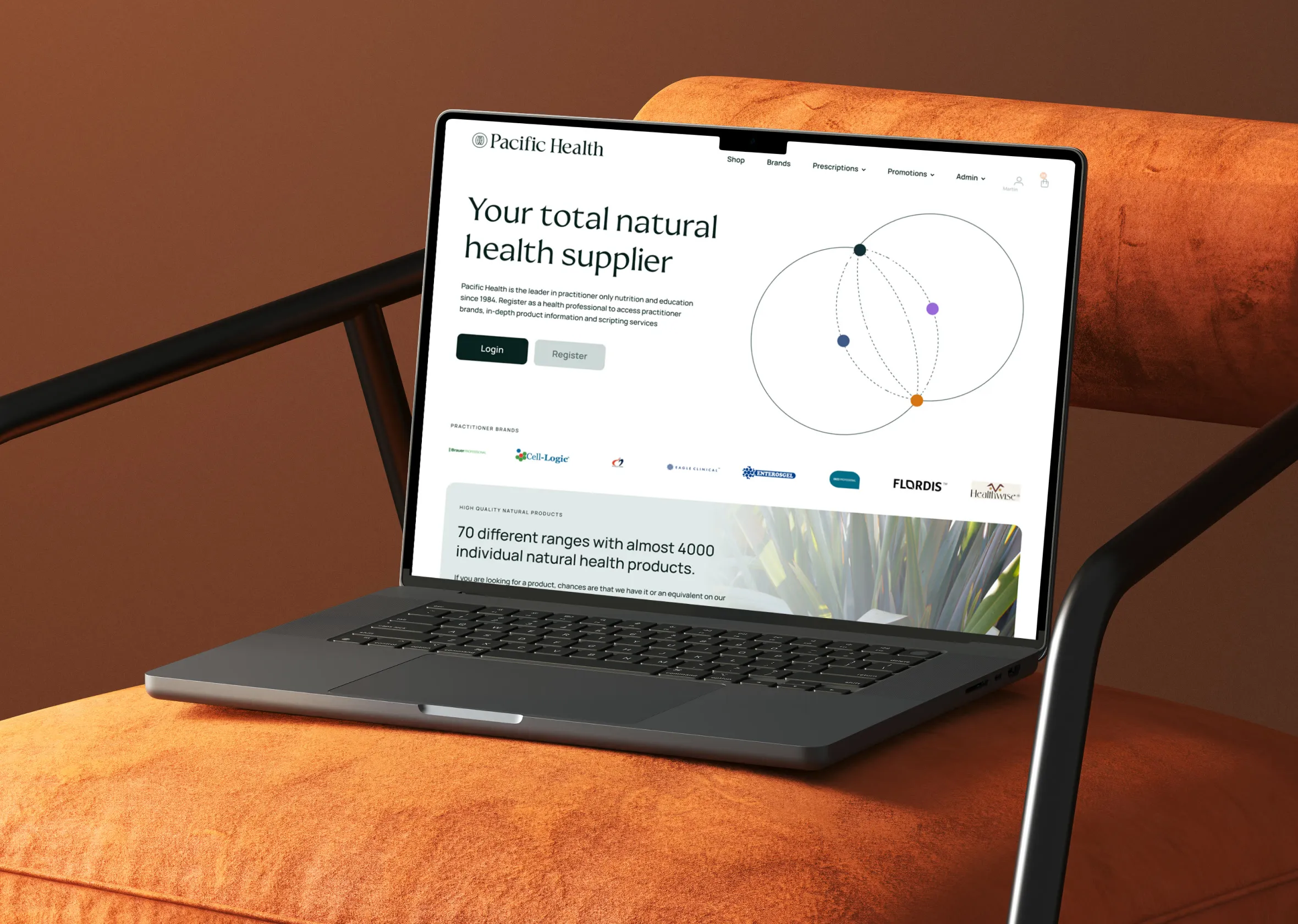 The Pacific Health home page on a laptop resting on an orange chair.